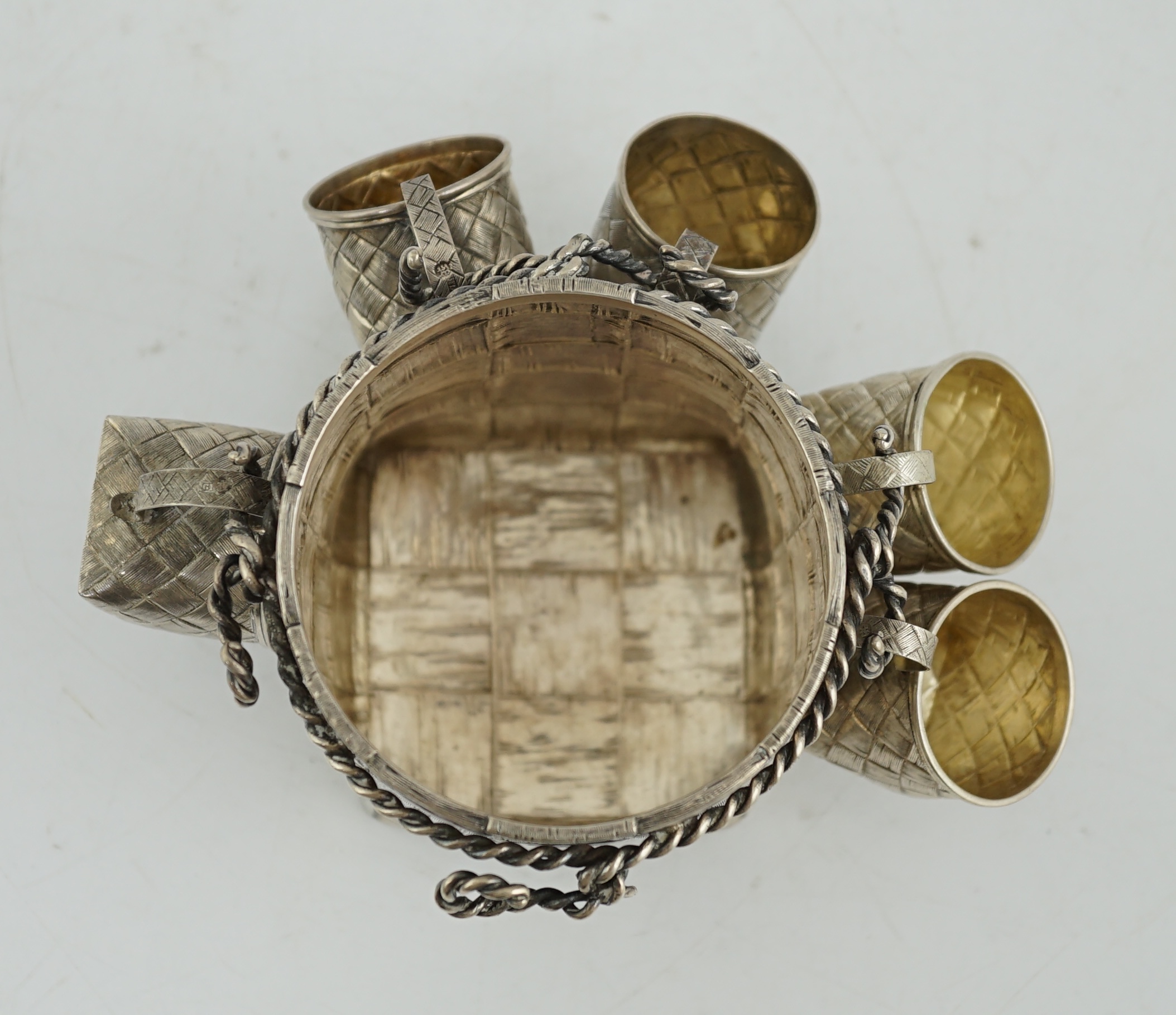 A late 19th century Russian 84 zolotnik silver bottle holder, with basket weave decoration, together with five similar tots